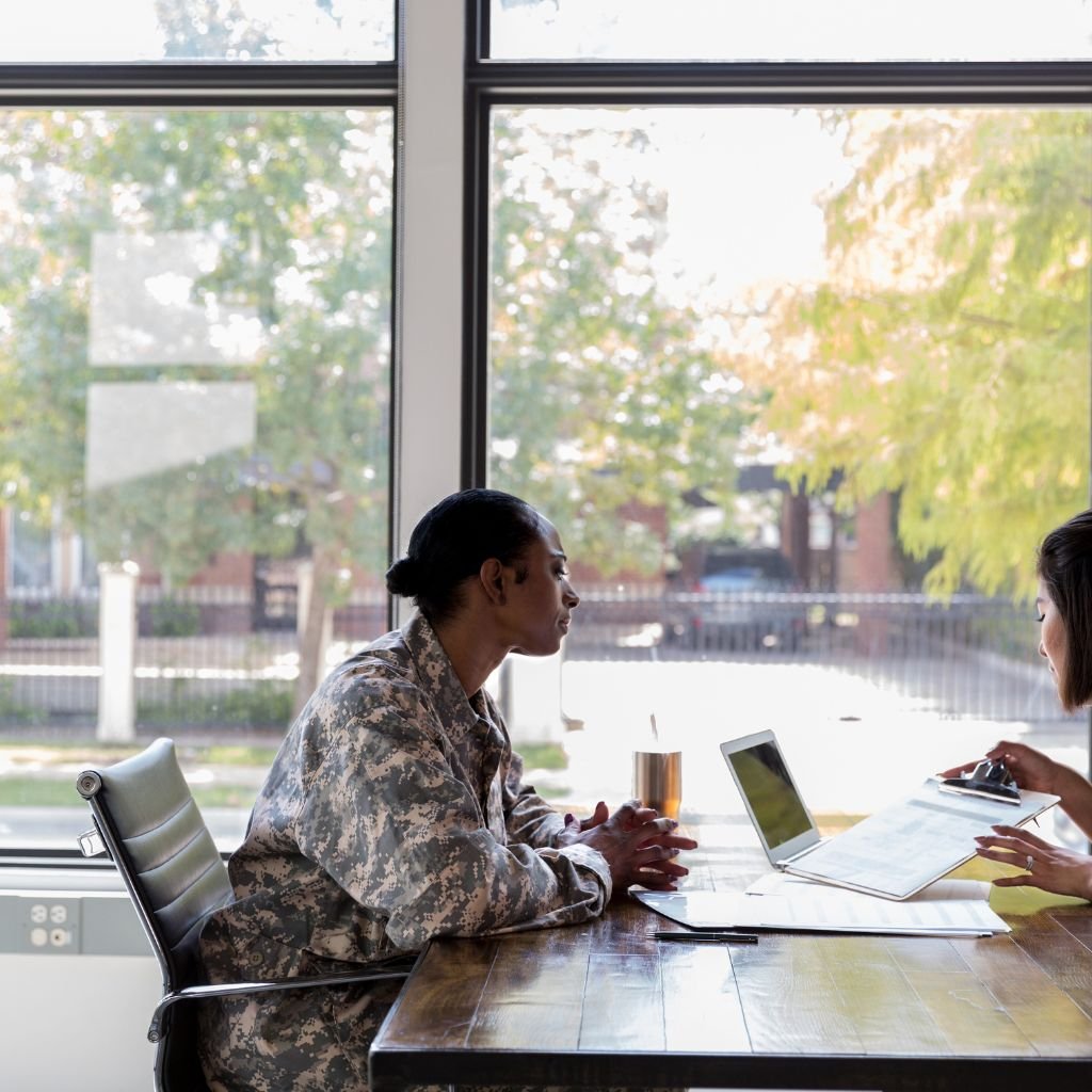 Adult child helping a parent review military records and DD214 paperwork